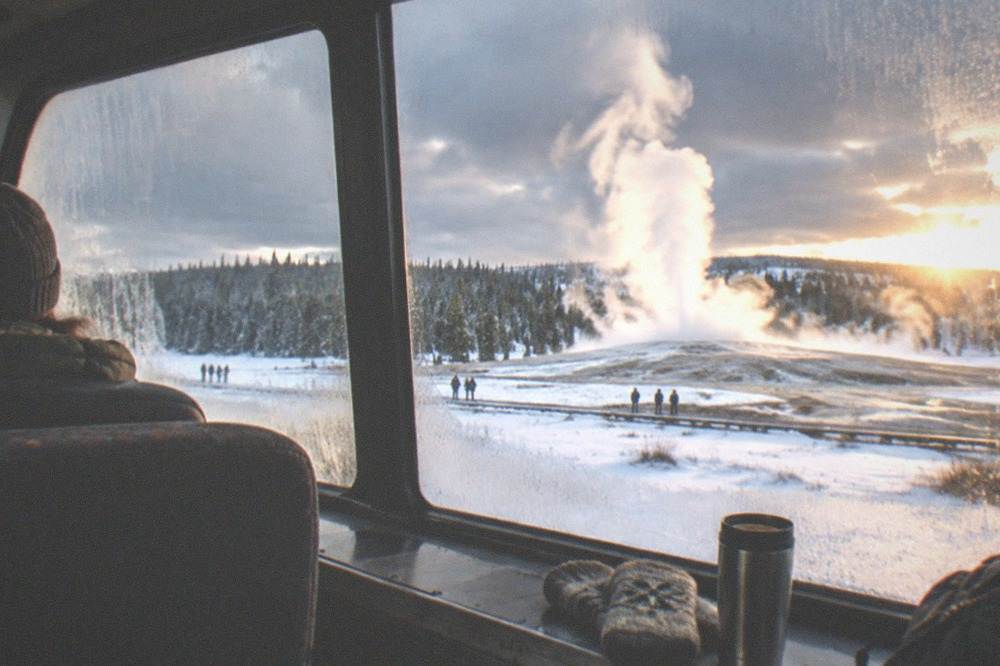 A heated snowcoach interior with large windows facing snow-covered terrain